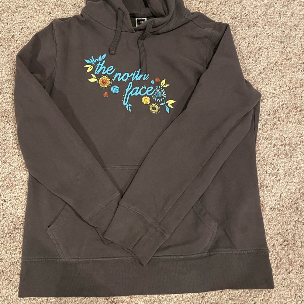 A grey, women’s North Face hoodie. It is in good shape and is an XL.